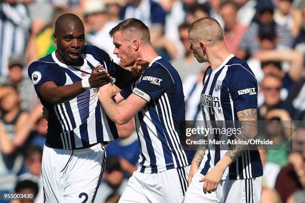 Chris Brunt of West Bromwich Albion tries to restrain team mate Allan Nyom during the Premier League match between West Bromwich Albion and Tottenham...