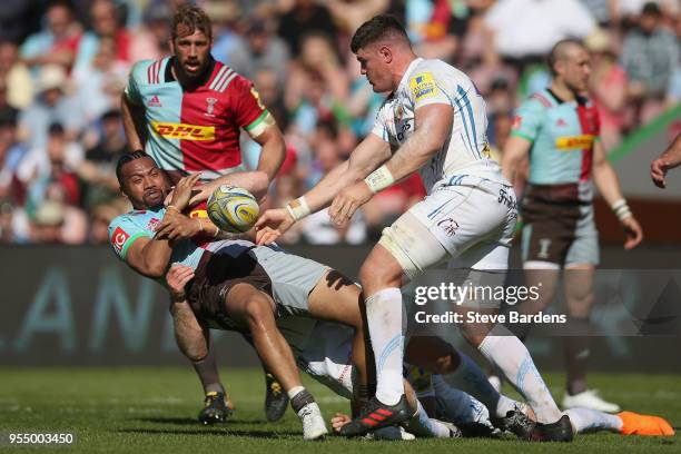 Alofa Alofa of Harlequins is tackled by Nic White, Thomas Waldrom and Dave Ewers of Exeter Chiefs during the Aviva Premiership match between...