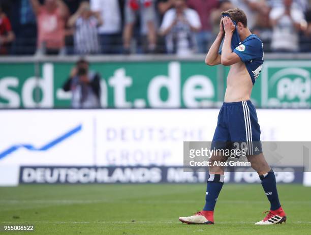 Matti Ville Steinmann of Hamburg covers his face after Alexander Meier of Frankfurt scored a goal to make it 3:0 during the Bundesliga match between...