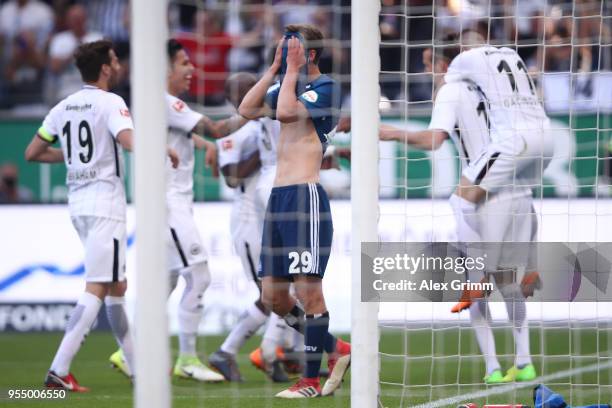 Matti Ville Steinmann of Hamburg covers his face after Alexander Meier of Frankfurt scored a goal to make it 3:0 during the Bundesliga match between...