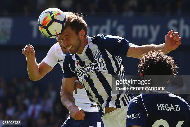 West Bromwich Albion's English defender Craig Dawson vies with Tottenham Hotspur's English striker Harry Kane to head the ball during the English...