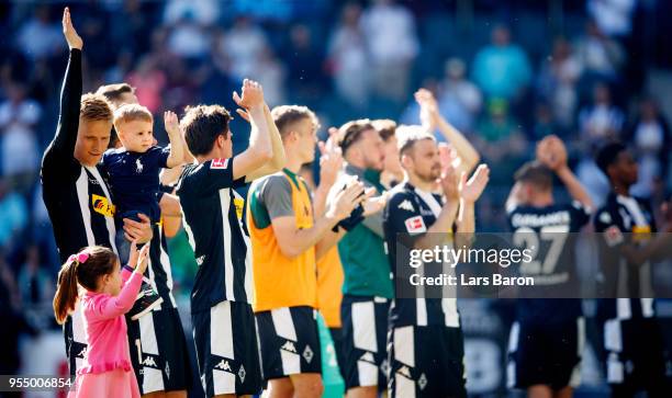 Oscar Wendt of Moenchengladbach celebrates with his kids and his team mates after winning the Bundesliga match between Borussia Moenchengladbach and...