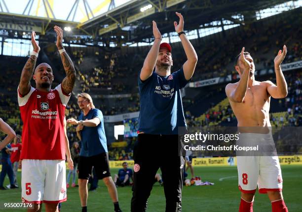 Nigel de Jong, head coach Sandro Schwarz and Levin Oeztunali of Mainz celebrates avoiding the relegation after winning 2-1 the Bundesliga match...