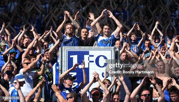 Felix Schiller, goalkeeper Jan Glinker and Marius Sowislo of 1. FC Magdeburg celebrate with the fans after the 3. Liga match between 1. FC Magdeburg...