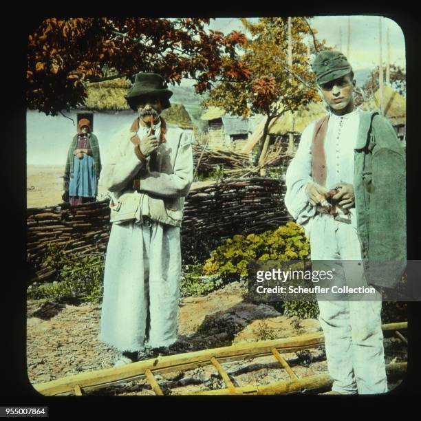 Ruthenian men in traditional dress, Two Ruthenian men stand in traditional dress in a village in the Southern Carpatho-Ukraine. Location: south...
