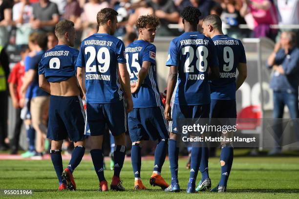 Players of Hamburg stand together dejected after the Bundesliga match between Eintracht Frankfurt and Hamburger SV at Commerzbank-Arena on May 5,...