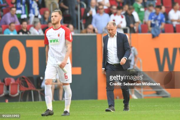 Jeffrey Gouweleeuw and Stefan Reuter of Augsburg walk on the pitch after the Bundesliga match between FC Augsburg and FC Schalke 04 at WWK-Arena on...