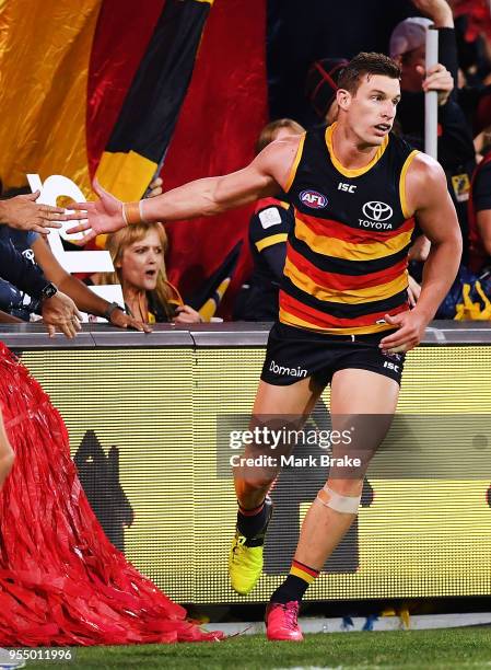 Josh Jenkins of the Adelaide Crows high fives a fan after kicking a goal during the round seven AFL match between the Adelaide Crows and the Carlton...