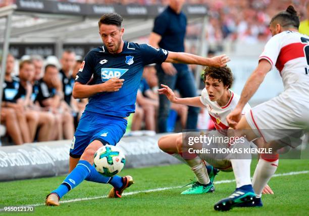 Stuttgart's Argentinean defender Emiliano Insua and French defender Benjamin Pavard vie with Hoffenheim's forward Mark Uth during the German first...