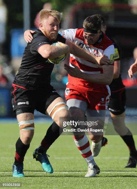 Jackson Wray of Saracens is tackled by Andy Symons during the Aviva Premiership match between Saracens and Gloucester Rugby at Allianz Park on May 5,...