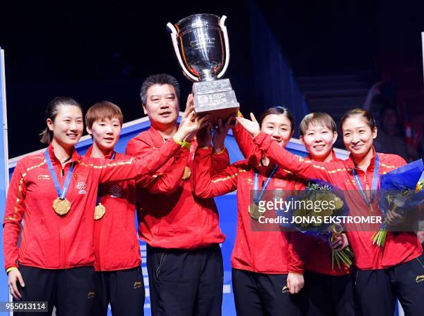 Chinese team's members pose with their trophy after winning the women's final at the World Team Table Tennis Championships in Halmstad, Sweden, on...