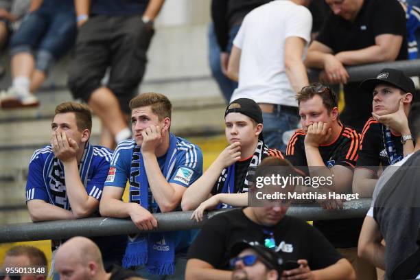 Dejected supporters of Hamburg look on after the Bundesliga match between Eintracht Frankfurt and Hamburger SV at Commerzbank-Arena on May 5, 2018 in...