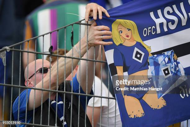 Dejected supporter of Hamburg removes a banner from the fence, after the Bundesliga match between Eintracht Frankfurt and Hamburger SV at...