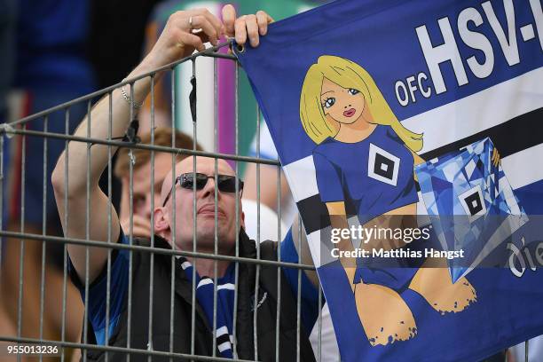 Dejected supporter of Hamburg removes a banner from the fence, after the Bundesliga match between Eintracht Frankfurt and Hamburger SV at...