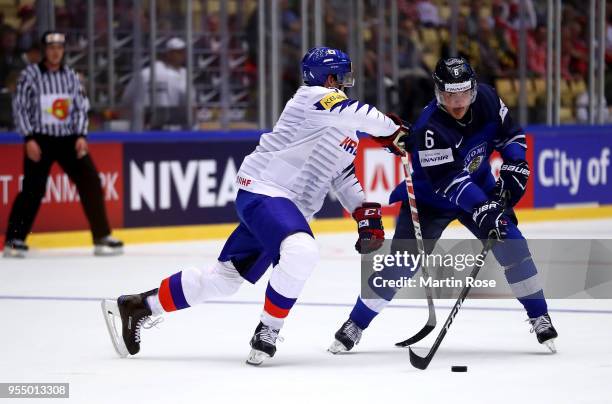 Julius Honka of Finland and Bryan Young of Korea battle for the puck during the 2018 IIHF Ice Hockey World Championship group stage game between...