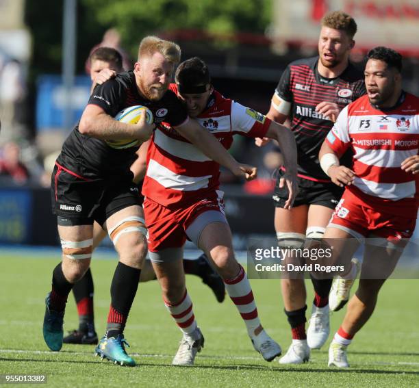 Jackson Wray of Saracens is tackled by Andy Symons during the Aviva Premiership match between Saracens and Gloucester Rugby at Allianz Park on May 5,...