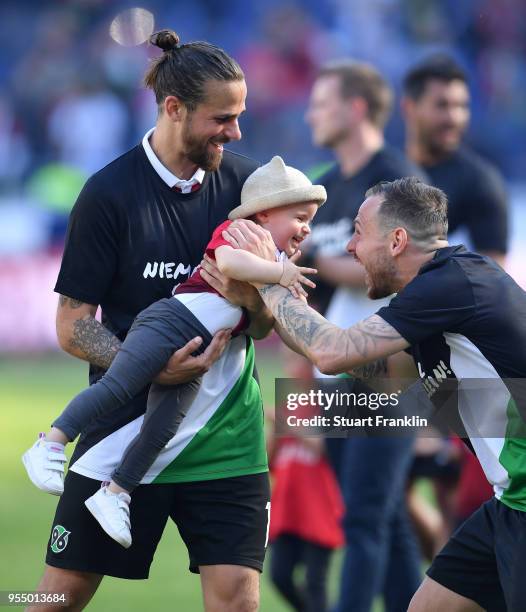 Martin Harnik of Hannover and child after the Bundesliga match between Hannover 96 and Hertha BSC at HDI-Arena on May 5, 2018 in Hanover, Germany.