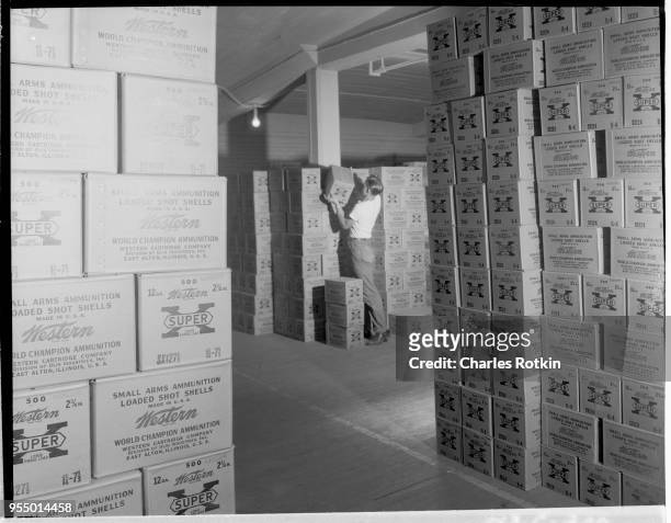 Stacked cases of ammunition, Stacked cases of ammunition awaiting shipment at the ammunition division of East Alton Works. Location: East Alton,...