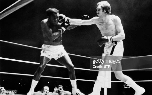 French middleweight boxer Jean-Claude Bouttier lands a punch against US middleweight boxer Emile Griffith during a middleweight boxing match at the...