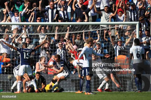 West Brom players celebrate with Jake Livermore after he scores an injury time goal during the Premier League match between West Bromwich Albion and...