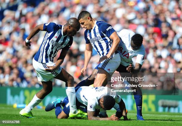 Tottenham Hotspur's Danny Rose is tackled by West Bromwich Albion's Allan-Romeo Nyom and Jake Livermore during the Premier League match between West...