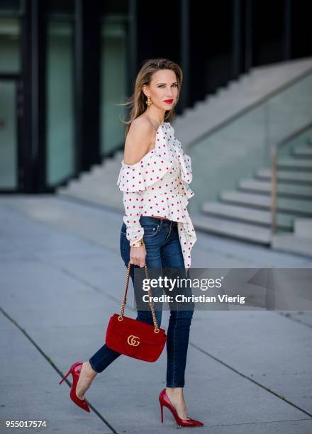 Alexandra Lapp wearing a white Self-Portrait asymmetric top with red dots, dark blue skinny Adriano Goldschmied jeans, a red GG Marmont velvet...