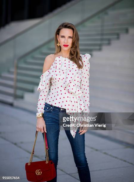 Alexandra Lapp wearing a white Self-Portrait asymmetric top with red dots, dark blue skinny Adriano Goldschmied jeans, a red GG Marmont velvet...