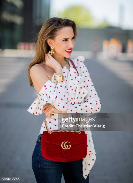 Alexandra Lapp wearing a white Self-Portrait asymmetric top with red dots, dark blue skinny Adriano Goldschmied jeans, a red GG Marmont velvet...