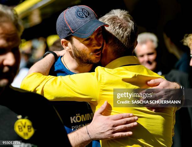 Dortmund's head coach Peter Stoeger greets Mainz's head coach Sandro Schwarz before the German first division Bundesliga football match Borussia...