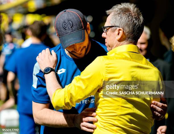 Dortmund's head coach Peter Stoeger greets Mainz's head coach Sandro Schwarz before the German first division Bundesliga football match Borussia...