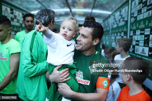 Zlatko Junuzovicy of Bremen and his son enters the pitch prior to the Bundesliga match between SV Werder Bremen and Bayer 04 Leverkusen at...