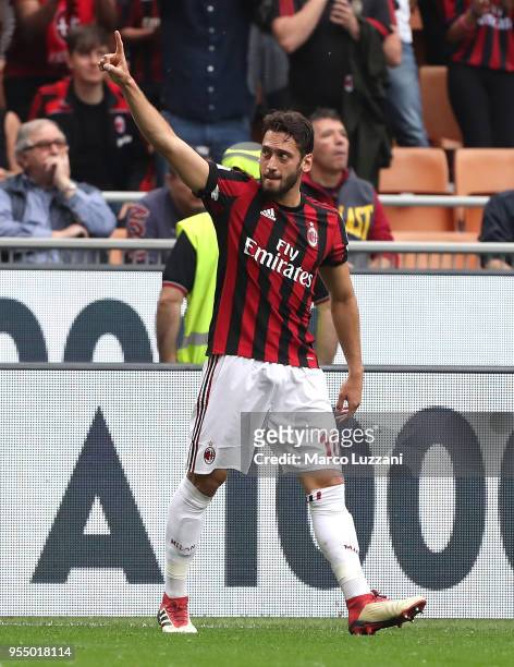 Hakan Calhanoglu of AC Milan celebrates after scoring the opening goal during the serie A match between AC Milan and Hellas Verona FC at Stadio...