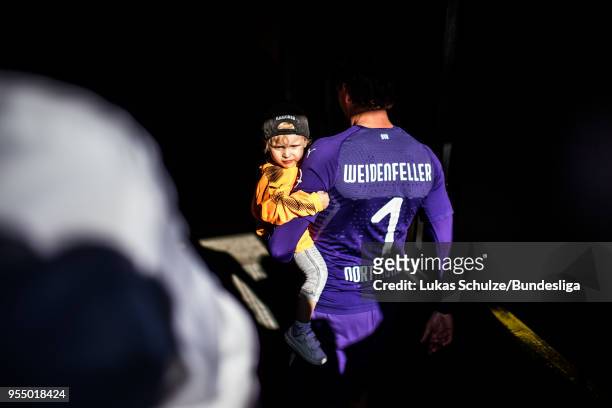 Goalkeeper Roman Weidenfeller of Dortmund and his son leave the pitch after last match at home after the Bundesliga match between Borussia Dortmund...