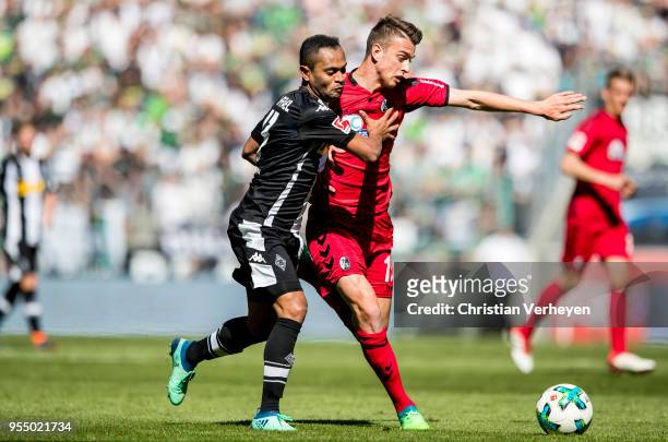 Raffael of Borussia Moenchengladbach and Pascal Stenzel of SC Freiburg battle for the ball during the Bundesliga match between Borussia...
