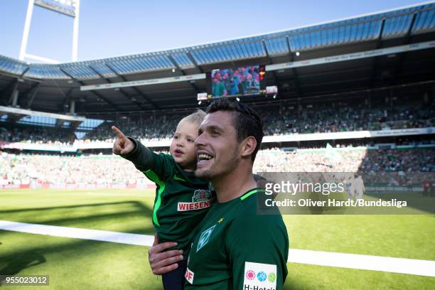 Zlatko Junuzovic of Bremen and his son celebrates with fans after the Bundesliga match between SV Werder Bremen and Bayer 04 Leverkusen at...