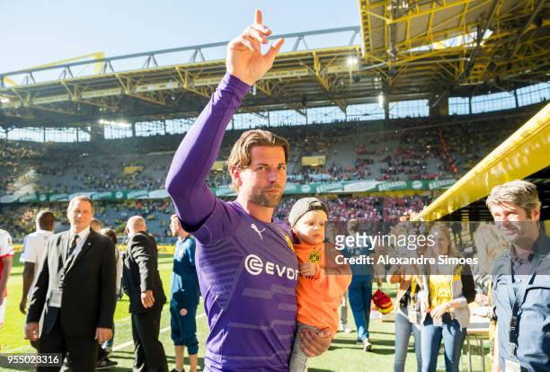 Goalkeeper Roman Weidenfeller of Borussia Dortmund celebrates his official goodbye after the final whistle during the Bundesliga match between...