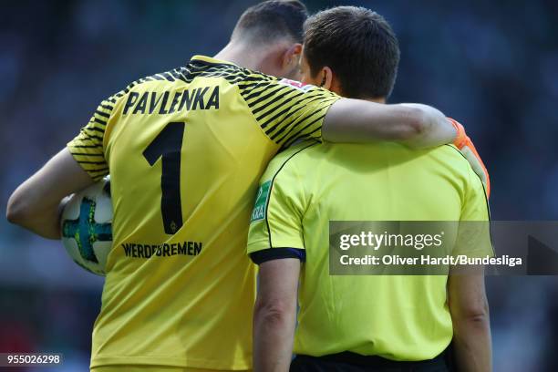 Jiri Pavlenka of Bremen and referee Robert Hartmann talks during the Bundesliga match between SV Werder Bremen and Bayer 04 Leverkusen at...