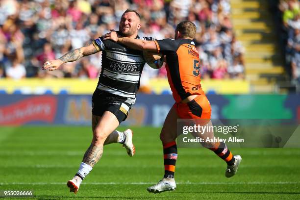 Josh Griffin of Hull FC is challenged by Paul McShane of Castleford Tigers during the Betfred Super League match between Hull FC and Castleford...