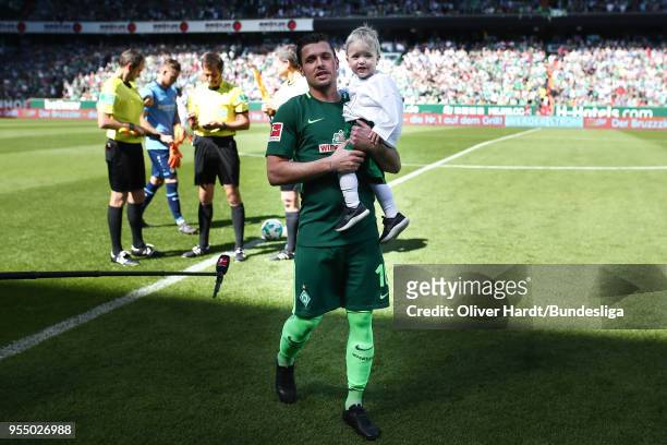 Zlatko Junuzovicy of Bremen and his son enters the pitch prior to the Bundesliga match between SV Werder Bremen and Bayer 04 Leverkusen at...