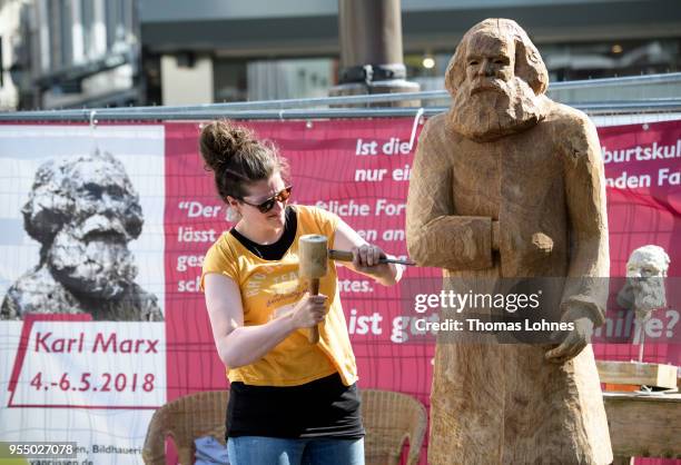 Artist Dana van Rijssen works on wooden sculpture of German philosopher and revolutionary Karl Marx on the 200th anniversary of the birth of Karl...