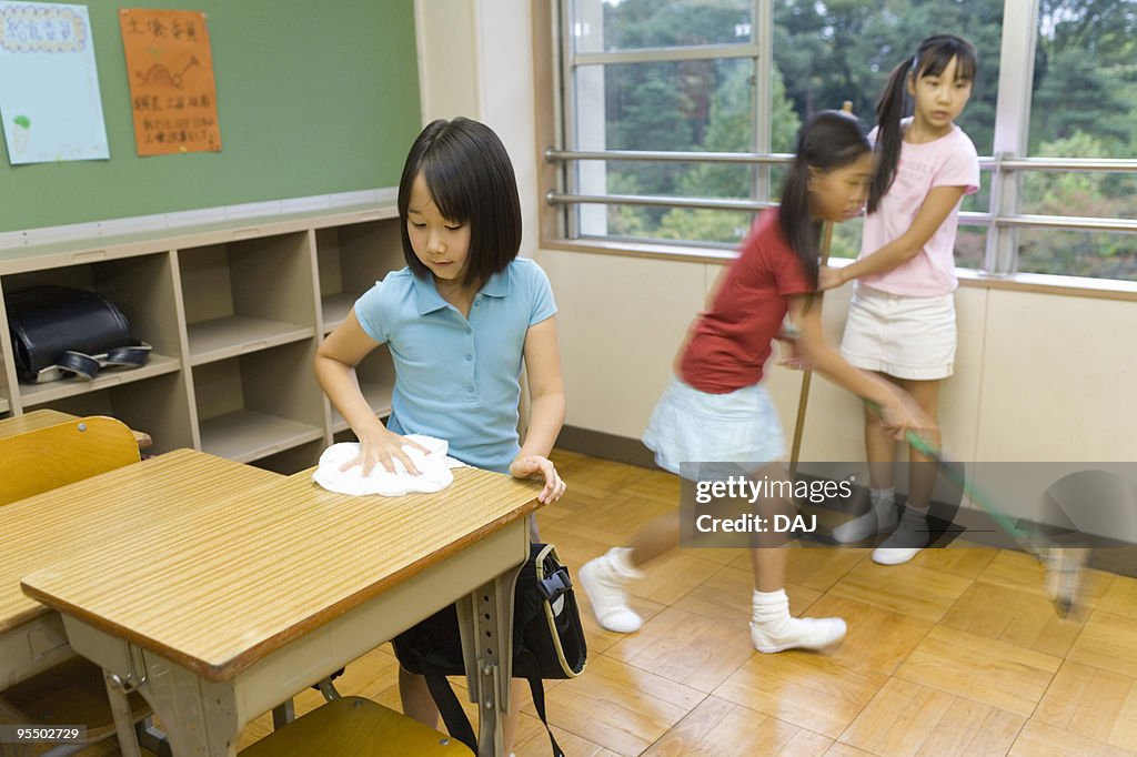 Students cleaning classroom
