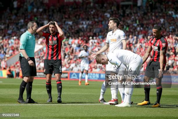 Andrew Surman of Bournemouth and Callum Wilson of Bournemouth try to convince referee Kevin Friend the foul was inside the box during the Premier...