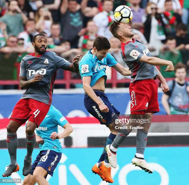 Manuel Fernandes and Maciej Rybus of FC Lokomotiv Moscow vie for the ball with Daler Kuzyayev of FC Zenit Saint Petersburg during the Russian...