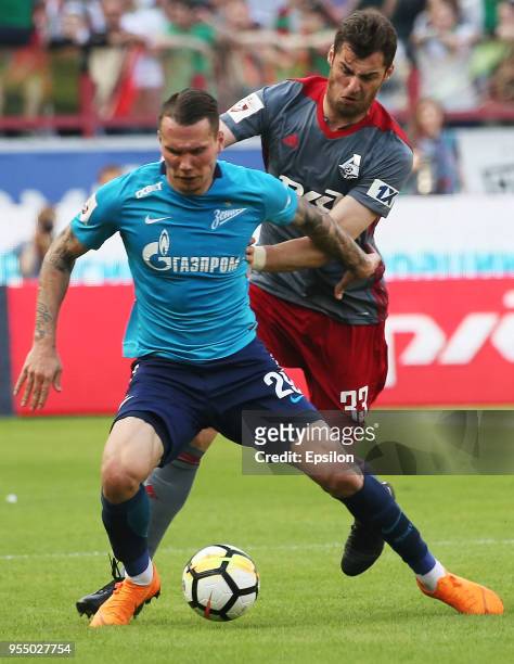 Solomon Kvirkvelia of FC Lokomotiv Moscow vie for the ball with Anton Zabolotny of FC Zenit Saint Petersburg during the Russian Football League match...
