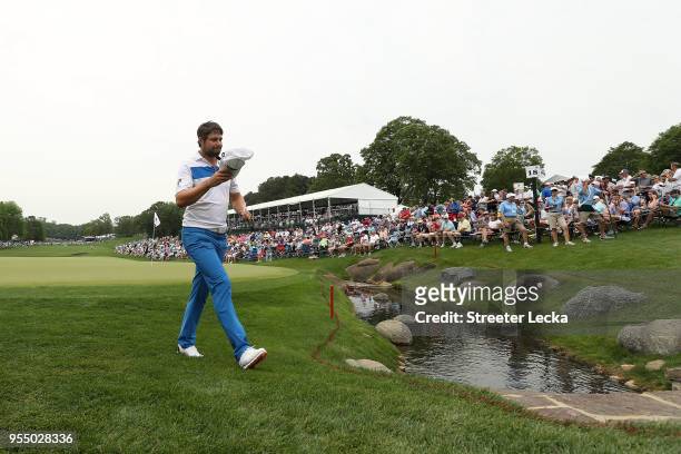 Peter Uihlein acknowledges the gallery as he walks off the 18th green during the third round of the 2018 Wells Fargo Championship at Quail Hollow...