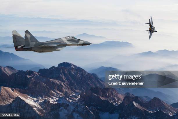 mig-29 fighter jets in flight above the mountains - russian air force stock pictures, royalty-free photos & images