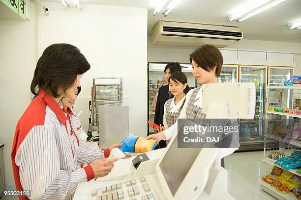 people waiting in line at cash register - checkout register stock pictures, royalty-free photos & images