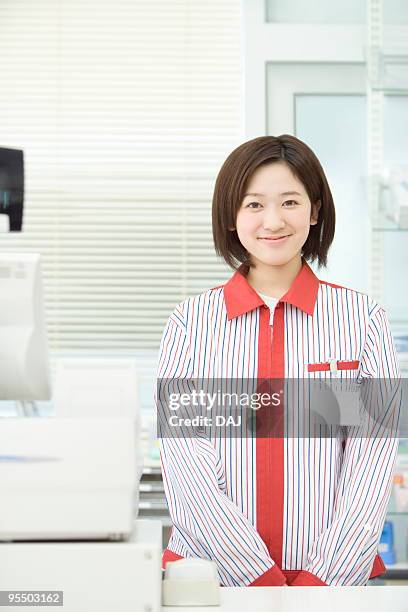 cashier at checkout counter - convenience store counter stock-fotos und bilder