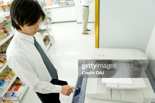 Using A Copy Machine Businessman Using Copy Machine At Convenience Store High-Res Stock ...