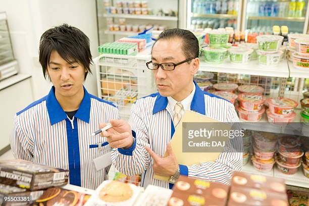 store manager talking to store clerk - itabashi ward stock pictures, royalty-free photos & images